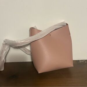 Samara light pink crossbody. Never used. Still has wrapping on strap.